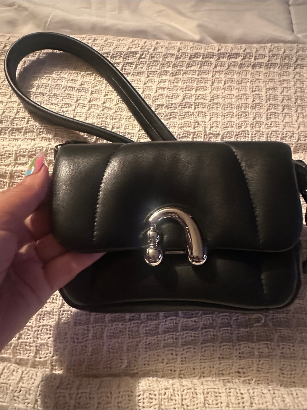 Black Quilted Crossbody Bag with Curved Metal Accent